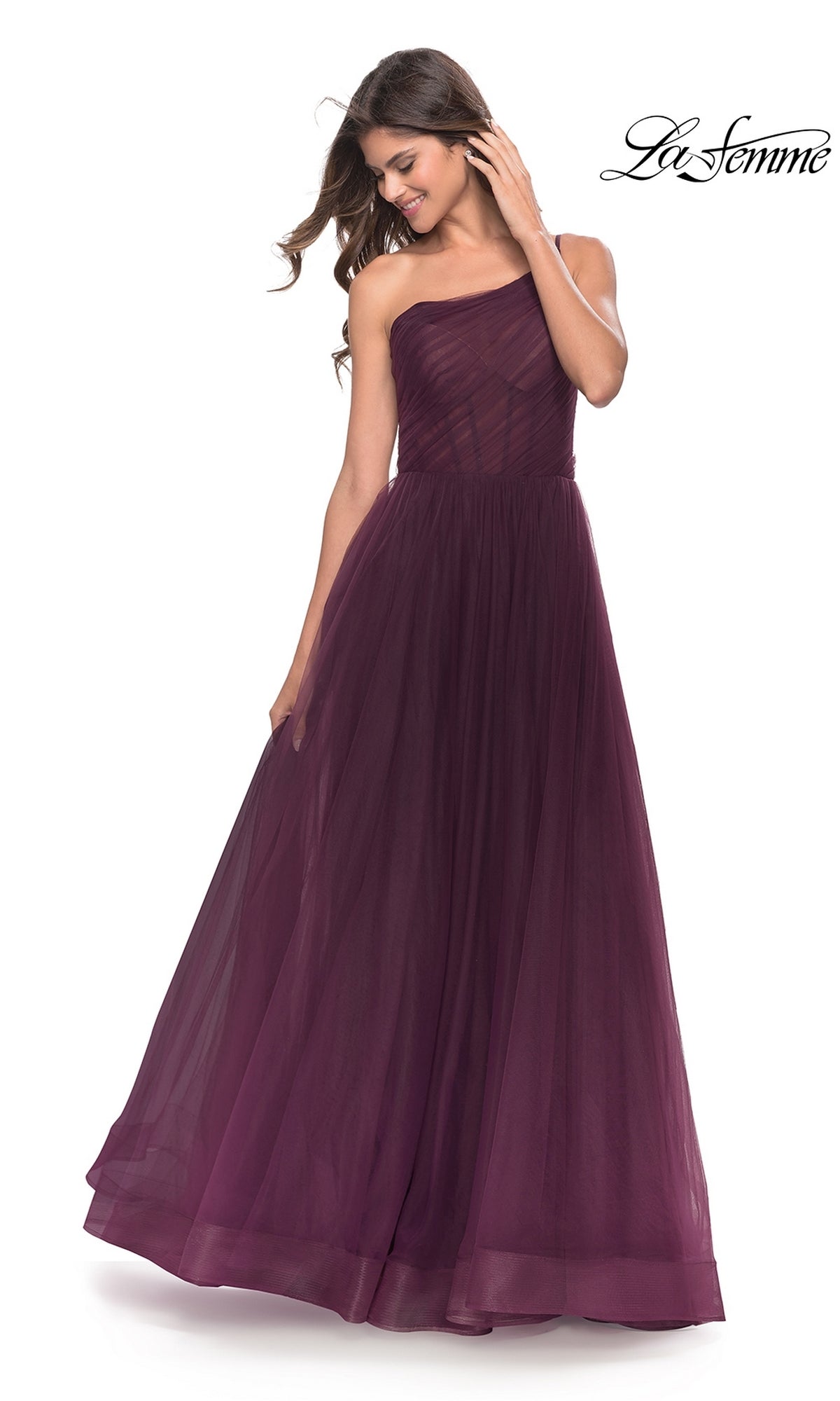 Smiling woman in a dark purple, floor-length One-Shoulder Sheer-Bodice Prom Ball Gown 31069 looks down; “La Femme” logo appears in the top right corner.